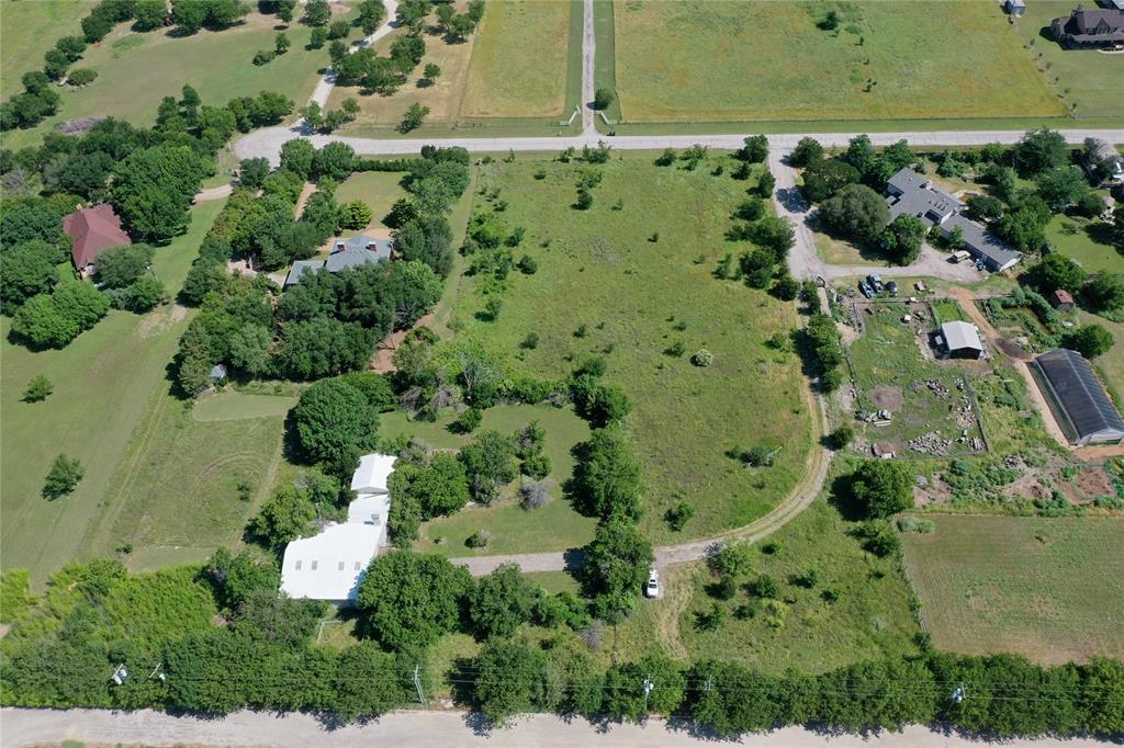 an aerial view of a residential houses with outdoor space and street view