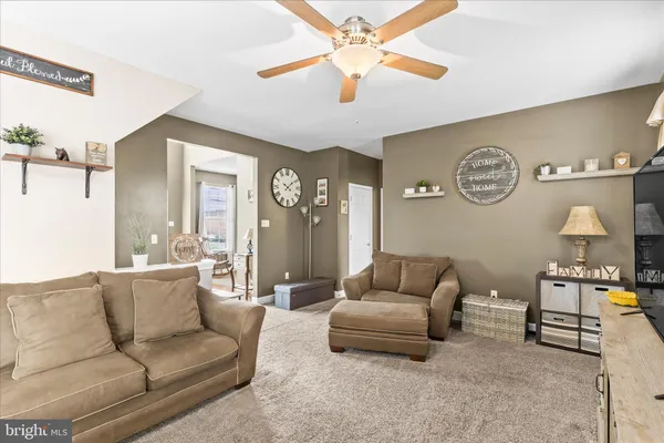 a living room with furniture and a mirror