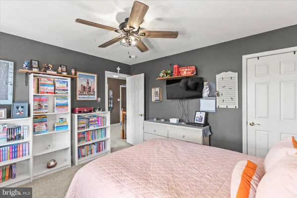 a bedroom with a bed and a couch