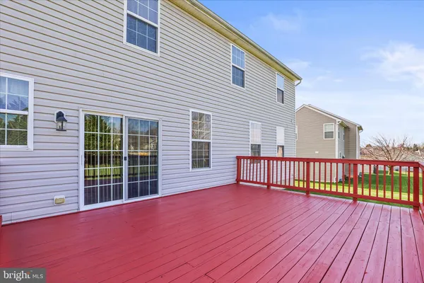 a view of a roof deck with wooden floor and fence