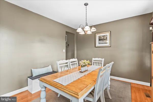 a view of a dining room with a table and chairs