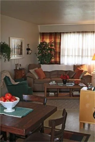 a living room with furniture and a floor to ceiling window