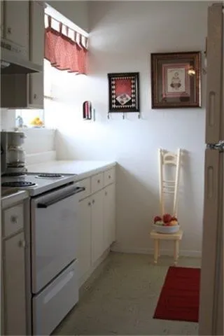 a kitchen with a refrigerator and a stove