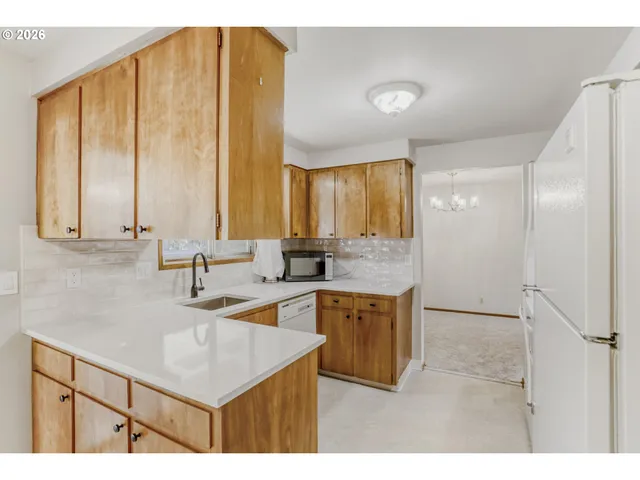 a kitchen with a sink cabinets and a window
