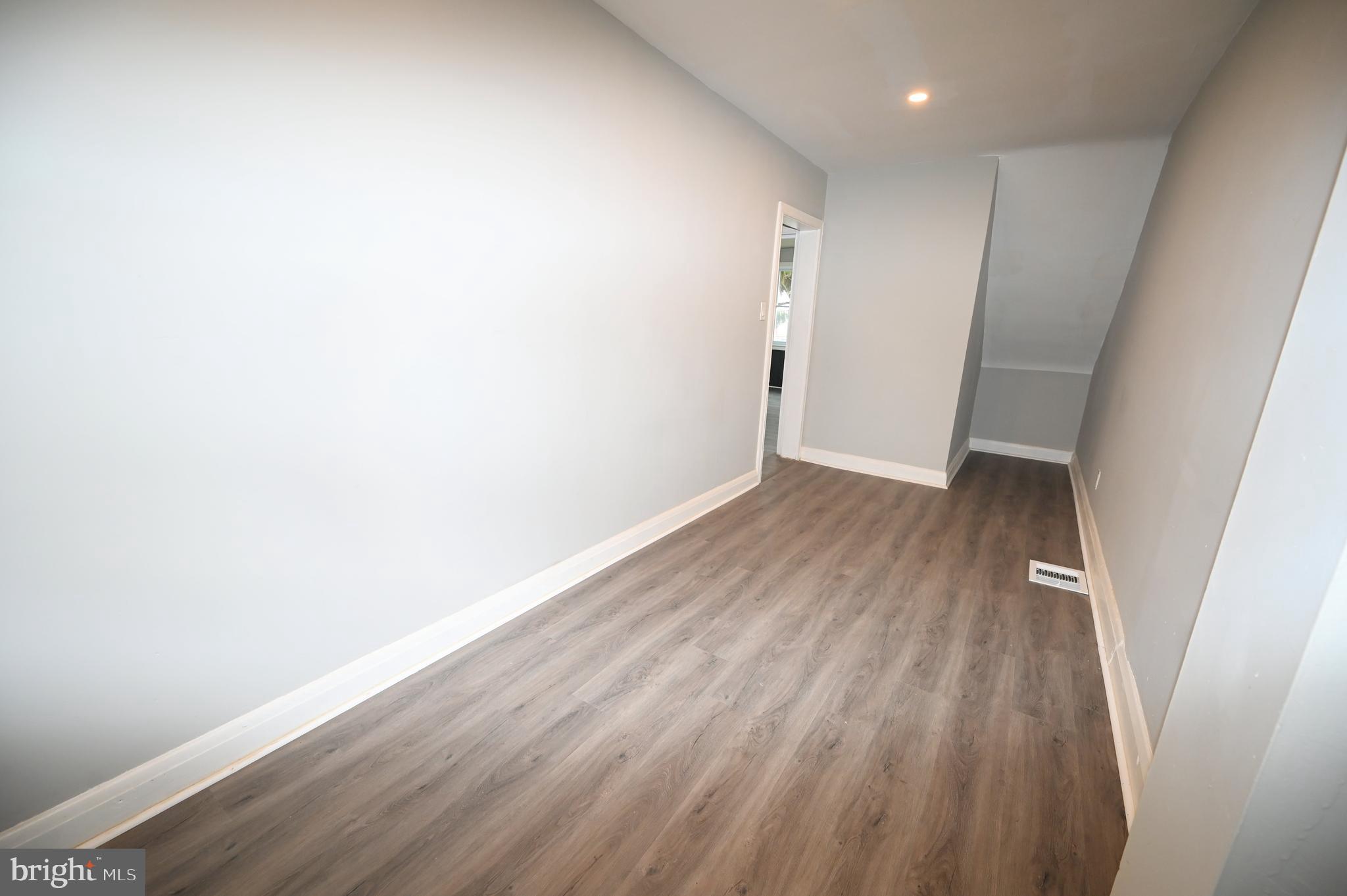 2952 Sollers Point Road, Unit B Dundalk, MD 21222 - Photo 20 of 37 a view of wooden floor in an empty room