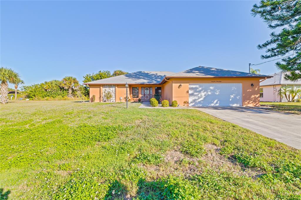 4138 Library Street Port Charlotte, FL 33948 - Photo 1 of 1 a front view of a house with a big yard