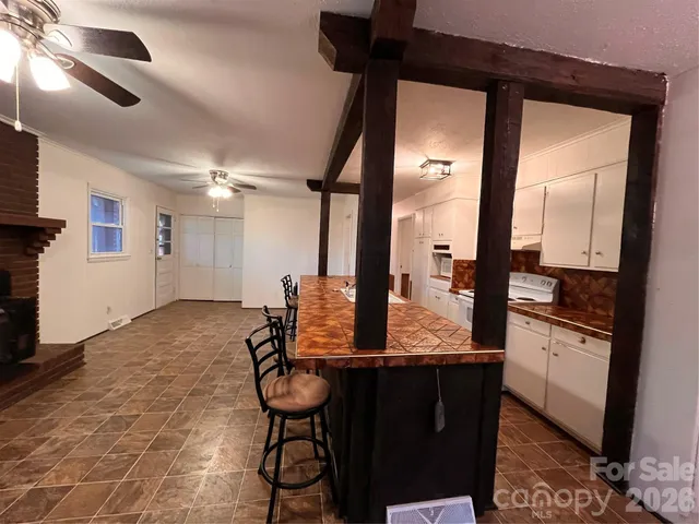 a view of a hallway with dining area and chandelier