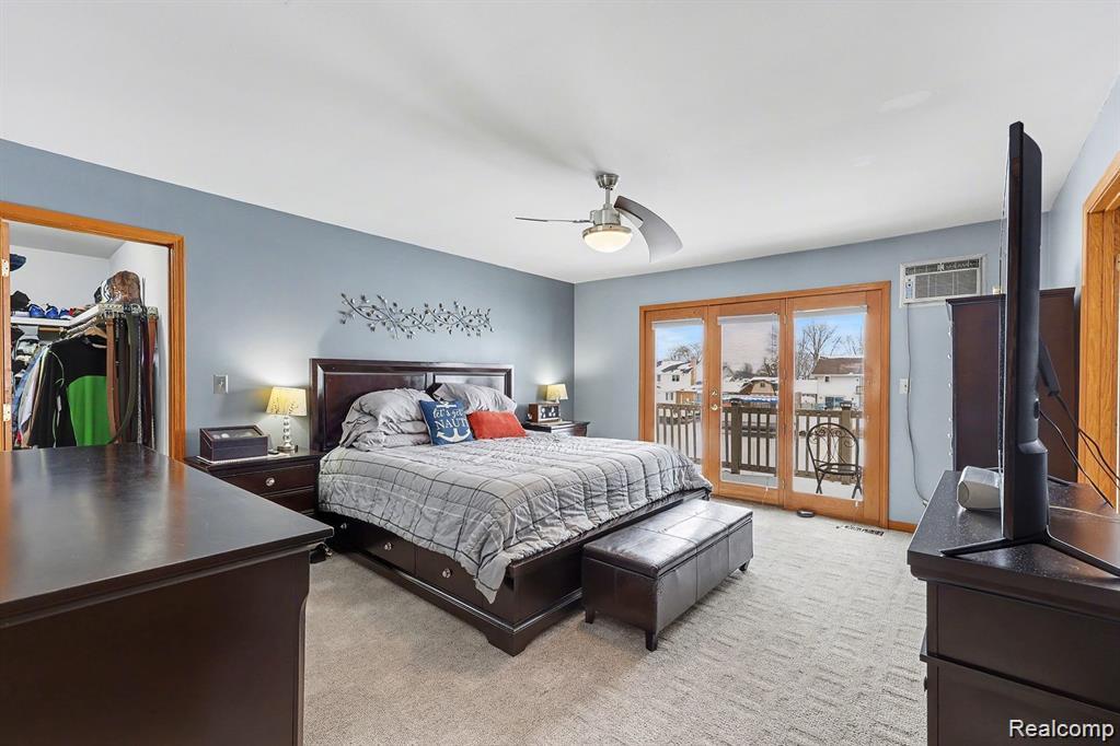 7277 Cardinal Road Algonac, MI 48001 - Photo 25 of 36 Bedroom with light carpet, access to exterior, and a ceiling fan
