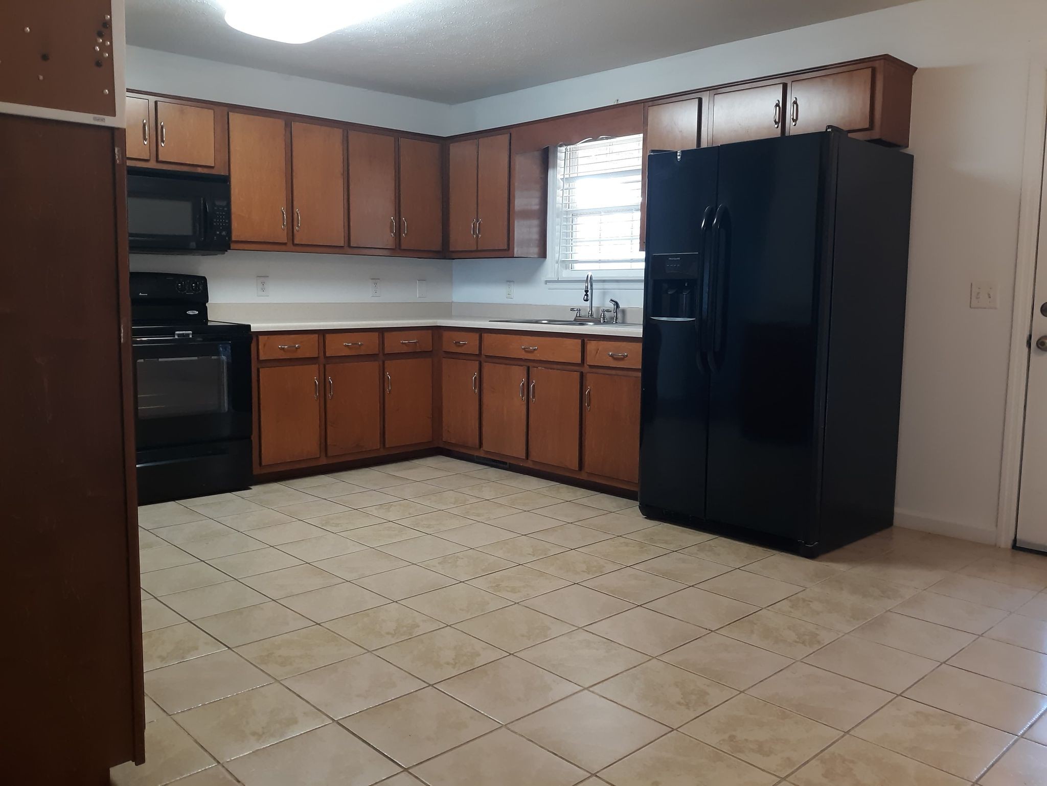 2122 Carthage Road Red Boiling Springs, TN 37150 - Photo 12 of 22 a kitchen with a refrigerator and cabinets