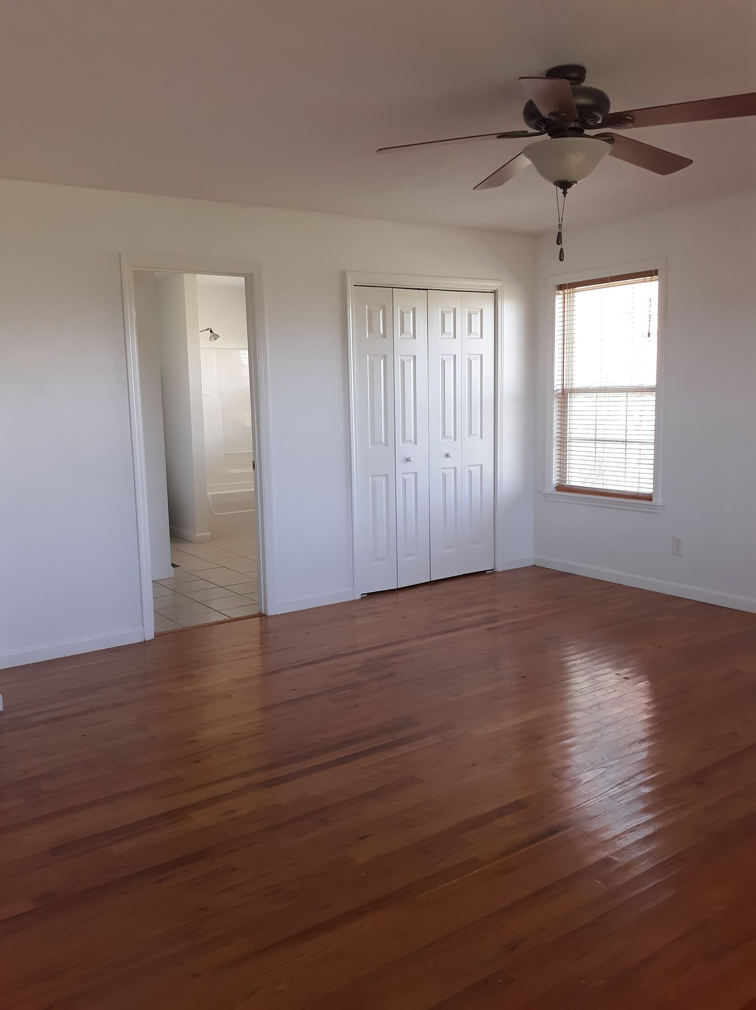 2122 Carthage Road Red Boiling Springs, TN 37150 - Photo 15 of 22 an empty room with wooden floor and windows