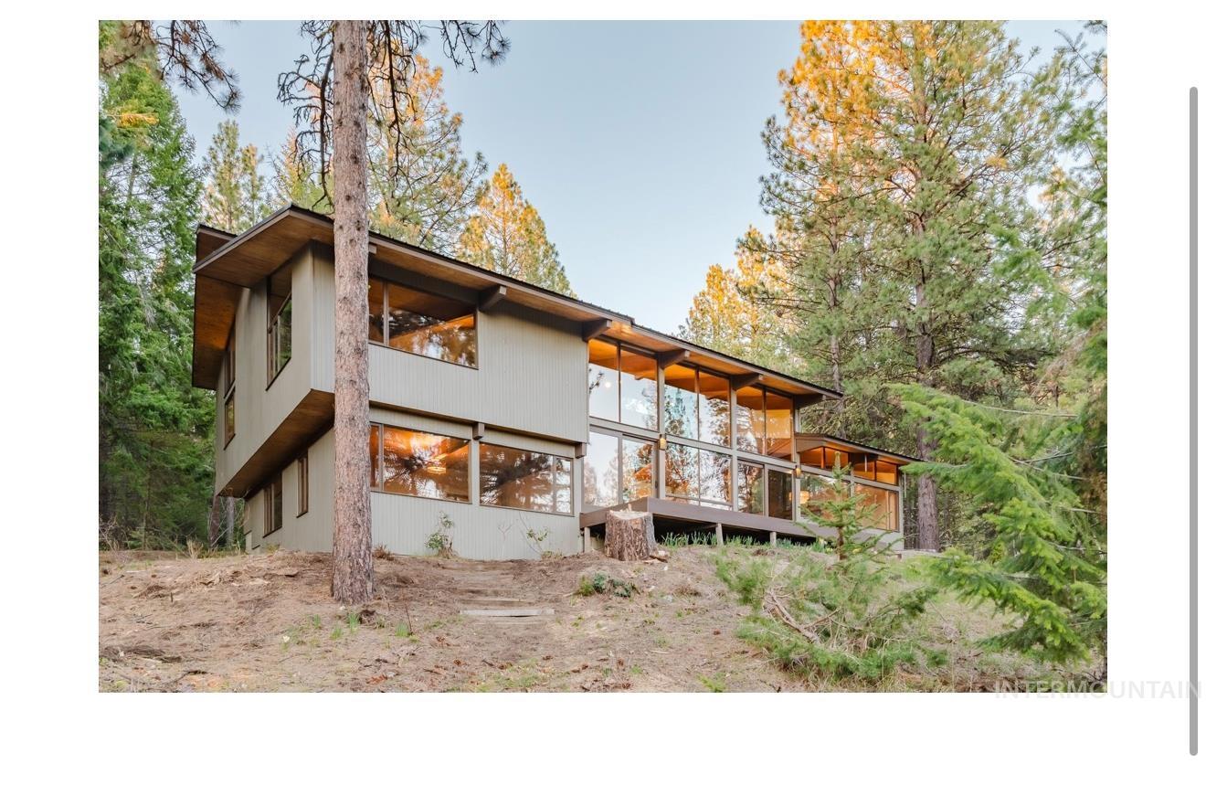 136 Silver Fox Trail McCall, ID 83638 - Photo 1 of 31 Modern exterior design featuring extensive glass paneling, a full-length balcony, and a flat roofline