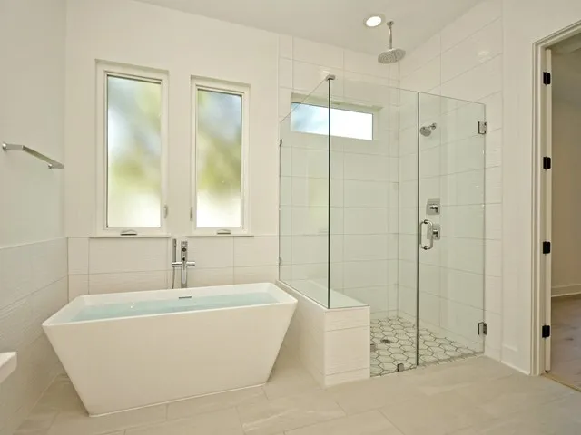a bathroom with a bathtub and shower