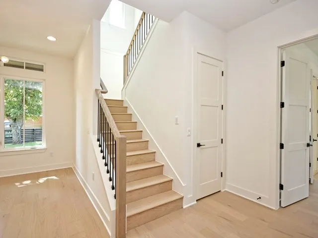 a view of a hallway with windows and entryway