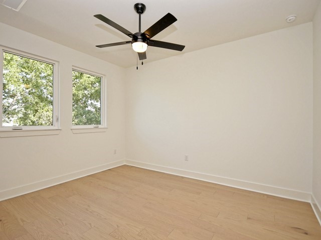 7500 St Cecelia Street Austin, TX 78757 - Photo 22 of 31 an empty room with a window and a fan