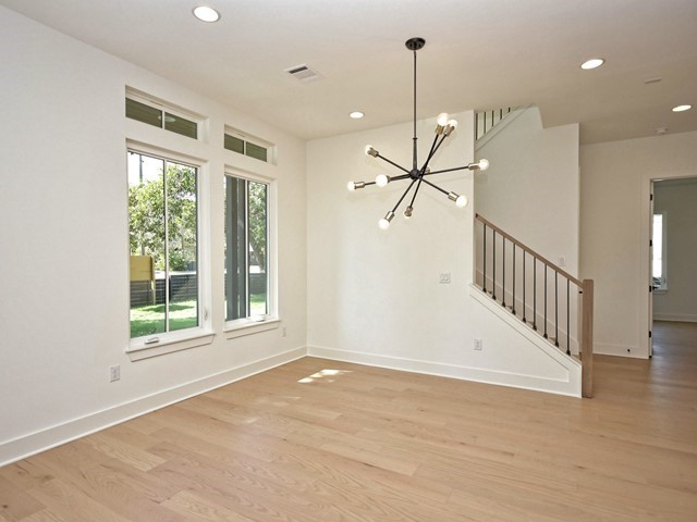 7500 St Cecelia Street Austin, TX 78757 - Photo 6 of 31 a view of empty room with wooden floor and fan