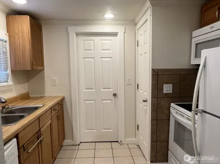 a kitchen with a sink and a refrigerator