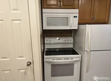 a stove top oven sitting inside of a kitchen