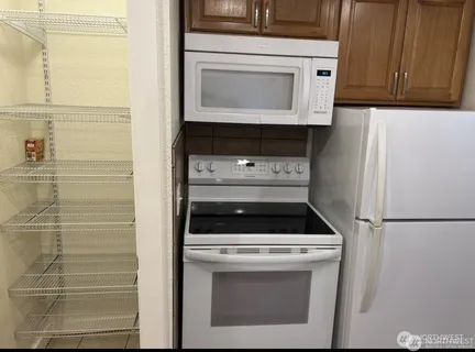 a stove top oven sitting inside of a kitchen
