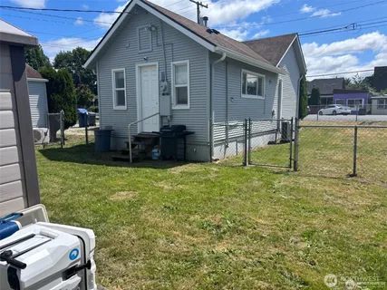 a backyard of a house with table and chairs