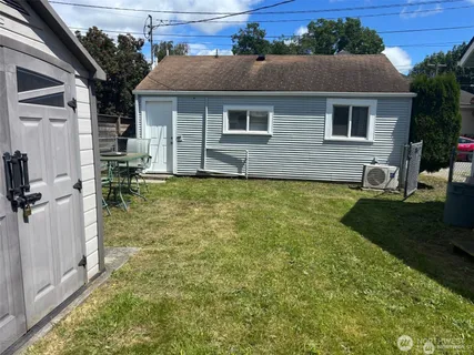 a view of a house with backyard porch and sitting area