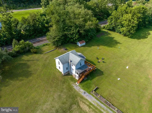 a aerial view of a house with a yard and deck