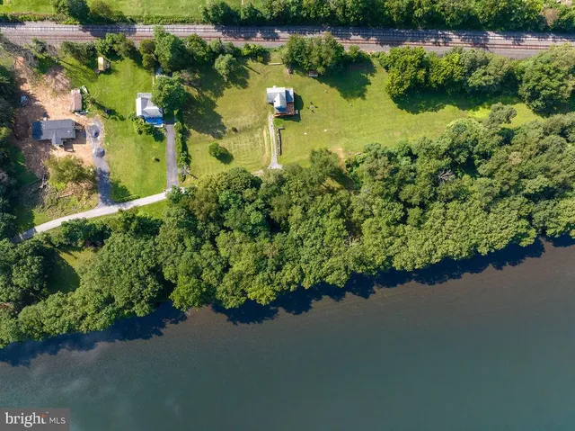 a view of a house with backyard and deck