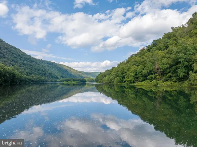 a aerial view of a house with a yard table and chairs