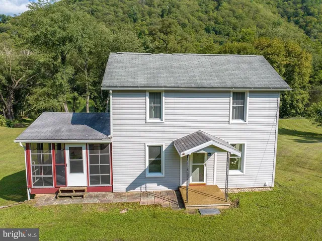 a spacious bedroom with a bed and a window