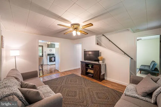 a dining room with large windows and wooden floor