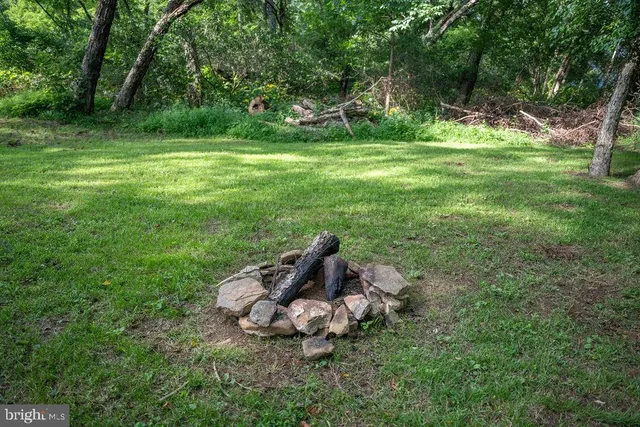 an aerial view of a house with a yard basket ball court and outdoor seating