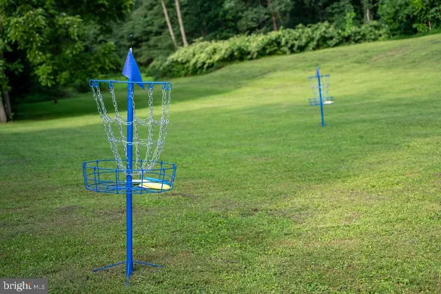 an aerial view of a house with a yard basket ball court and outdoor seating
