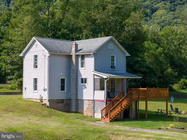 a aerial view of a house with swimming pool having outdoor seating