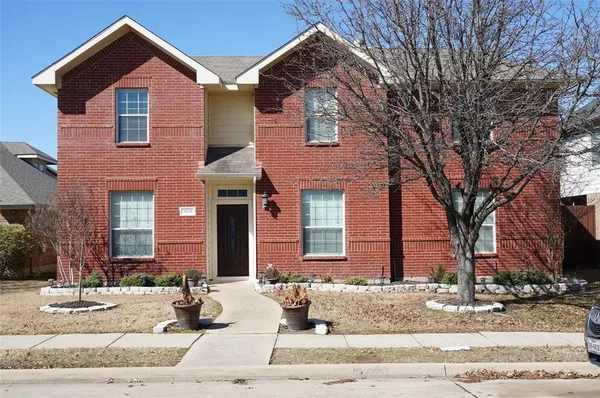 a view of a brick house with many windows
