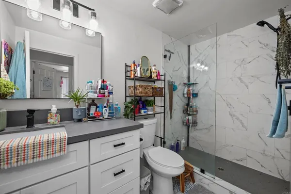 a bathroom with a sink toilet and shower