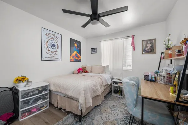 a bedroom with a bed and a desk