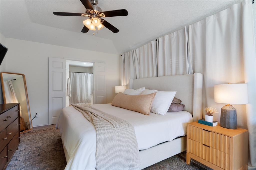 7518 Bayview Drive Rowlett, TX 75088 - Photo 11 of 22 Bedroom featuring ceiling fan, carpet, and ensuite bath