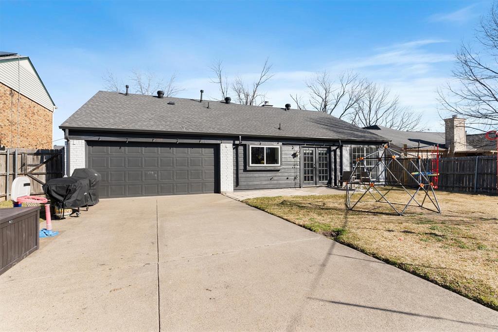 7518 Bayview Drive Rowlett, TX 75088 - Photo 19 of 22 View of front of home featuring roof with shingles, brick siding, and an attached garage