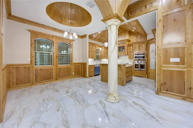a view of an entryway with wooden floor and a kitchen