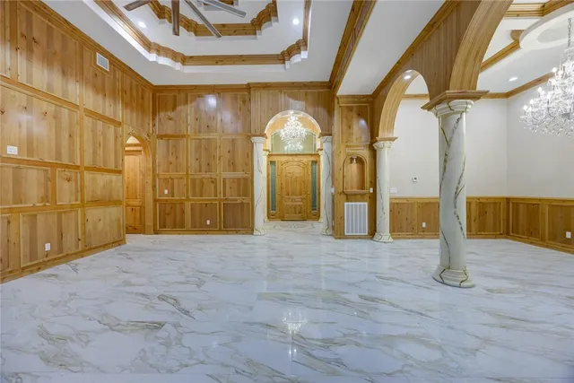 a large bathroom with a tub a sink and a large mirror