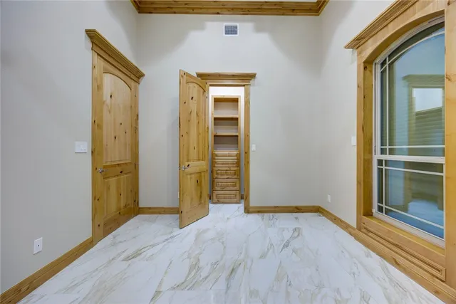 a bathroom with a granite countertop sink vanity mirror and toilet