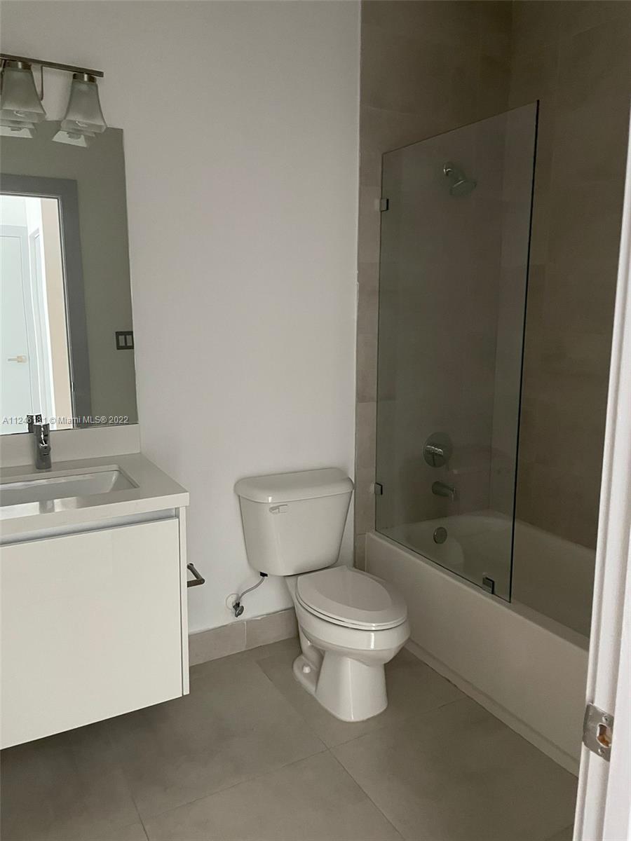 7220 Northwest 103rd Path Doral, FL 33178 - Photo 11 of 19 a bathroom with a toilet a sink and a bathtub