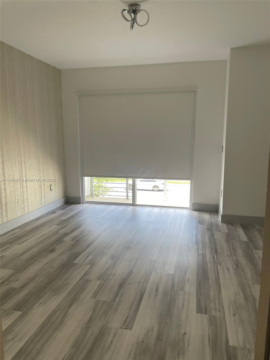 7220 Northwest 103rd Path Doral, FL 33178 - Photo 12 of 19 a view of empty room with wooden floor and fan