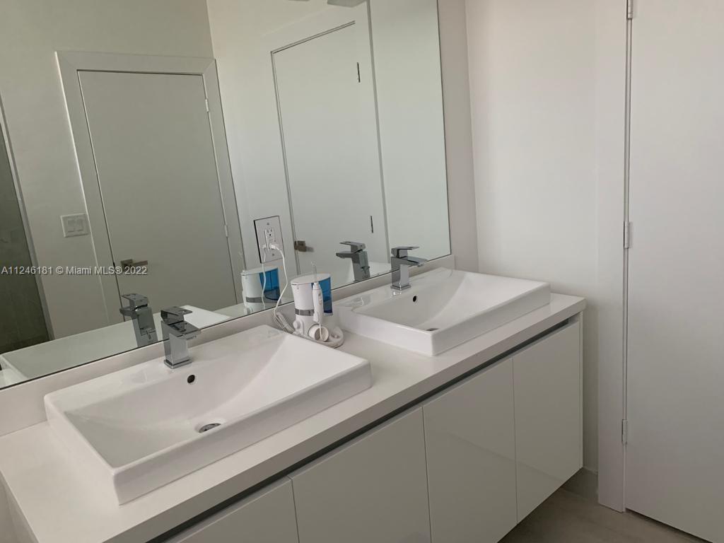 7220 Northwest 103rd Path Doral, FL 33178 - Photo 15 of 19 a bathroom with a sink and a mirror