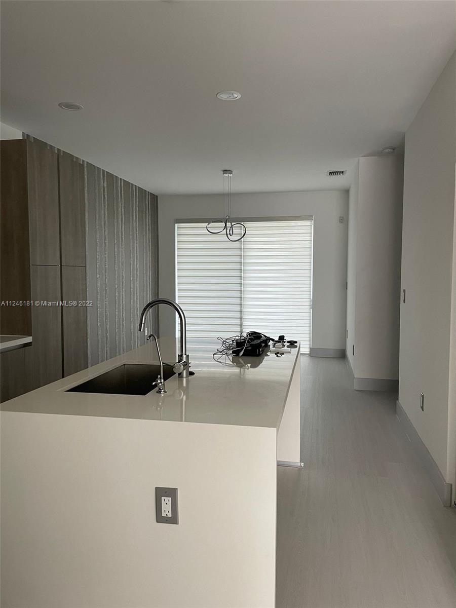 7220 Northwest 103rd Path Doral, FL 33178 - Photo 3 of 19 a kitchen with a sink and a refrigerator