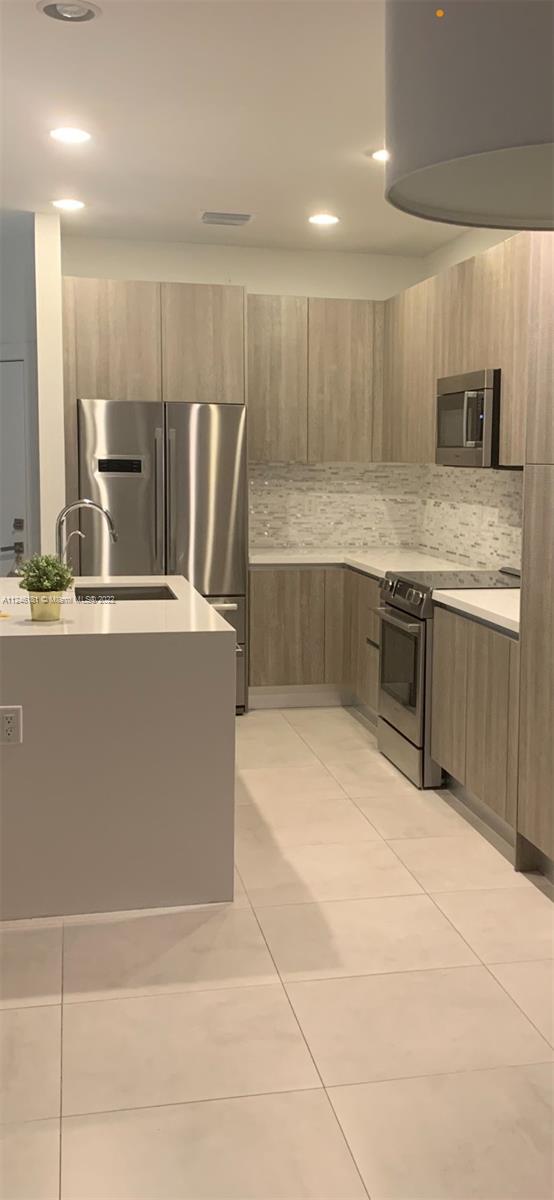 7220 Northwest 103rd Path Doral, FL 33178 - Photo 5 of 19 a large kitchen with granite countertop a sink and cabinets