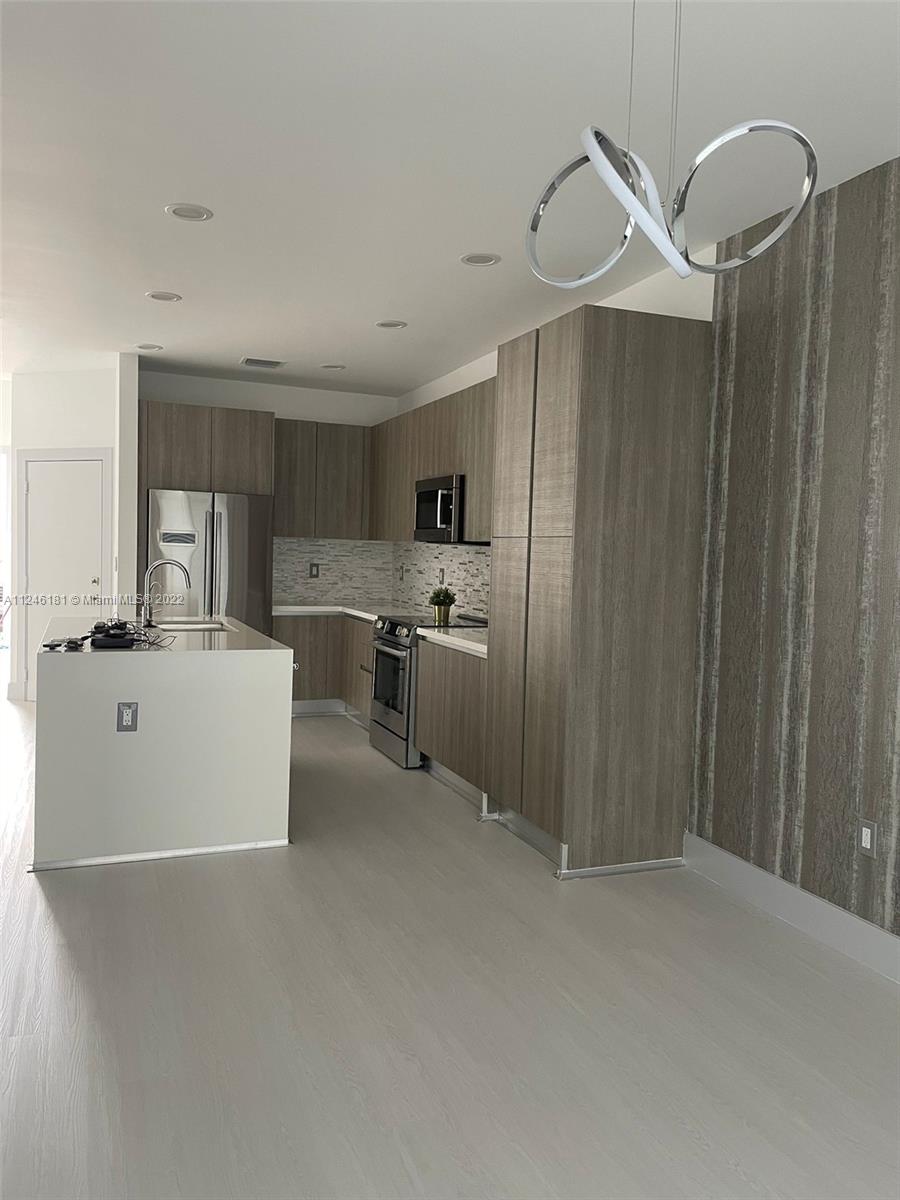 7220 Northwest 103rd Path Doral, FL 33178 - Photo 6 of 19 a view of kitchen with stainless steel appliances a refrigerator and a stove top oven