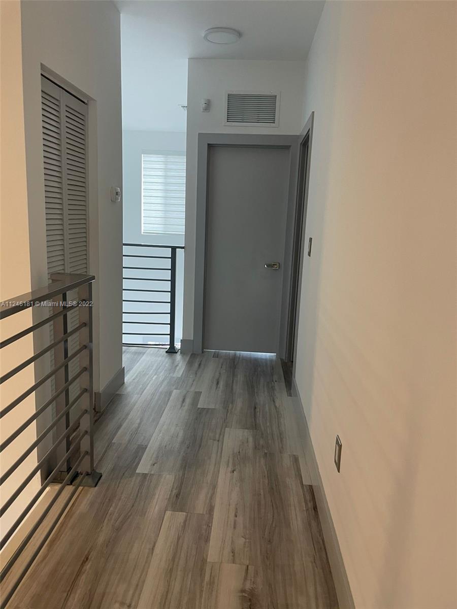7220 Northwest 103rd Path Doral, FL 33178 - Photo 10 of 19 a view of a hallway with wooden floor and staircase
