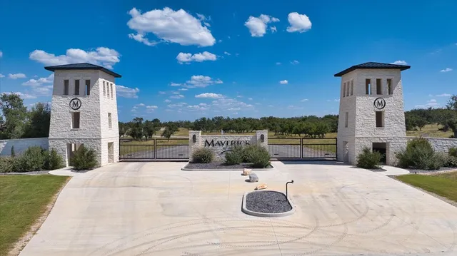 a swimming pool with an outdoor seating and a lots of potted plants