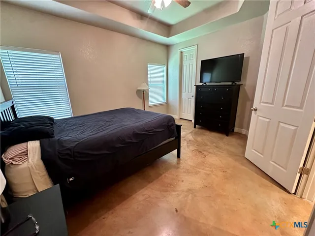 a bedroom with a bed and a television in it