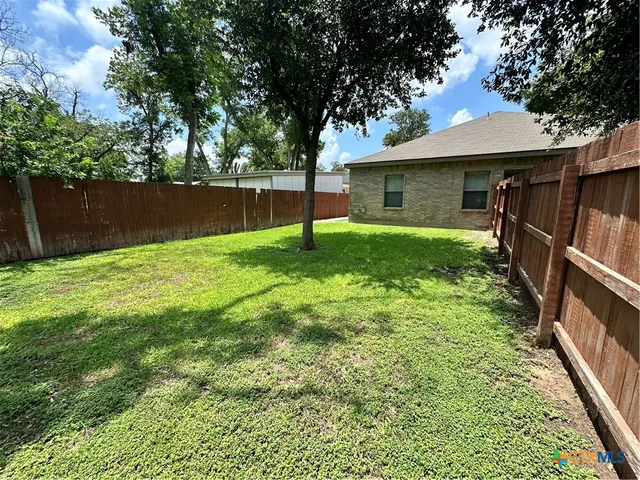 a view of roof deck with a barbeque and wooden stairs
